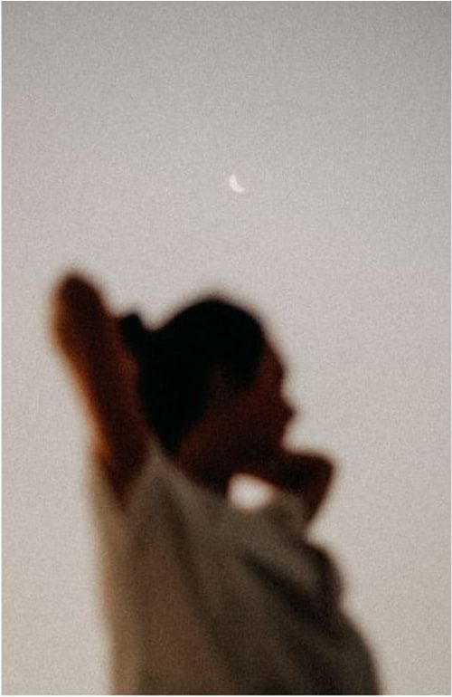 A person’s shadow cast on a pale wall